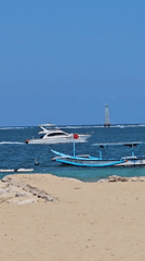 Colorful outrigger boats rest on a calm Bali beach