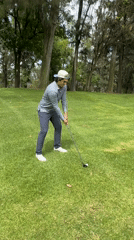 Man plays golf in park wearing casual attire