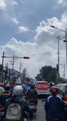 Motorcyclists wait at traffic light in Banjarkemantren, Indonesia