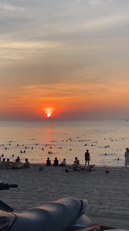 Nha Trang beach fills up at golden hour sunset