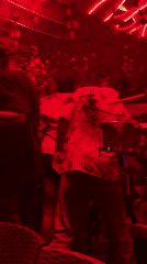 People dance and socialize at nightclub with live conga music