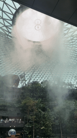 Morning visitors explore Jewel Changi Airport's indoor waterfall garden