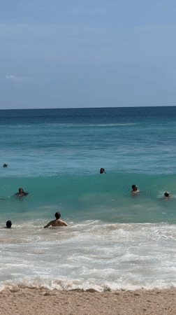 Beach activity documented at Kuta Selatan on sunny morning