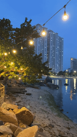 Couple takes selfies at Nha Trang waterfront amid city skyline
