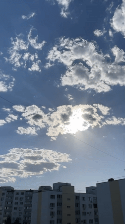 Camera captures sunny afternoon sky over Saratov apartment buildings