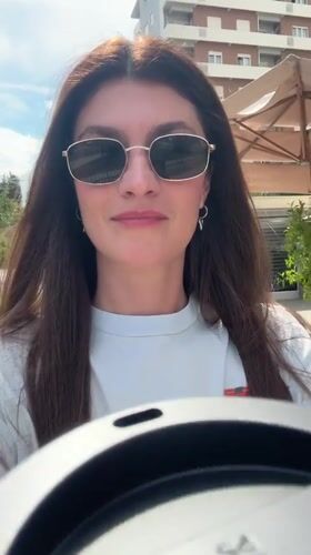 Woman enjoys coffee outdoors in sunny Podgorica