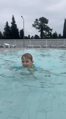 Family enjoys morning swim session in Abkhazia resort pool