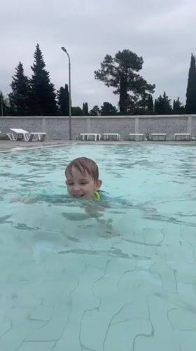 Family enjoys morning swim session in Abkhazia resort pool