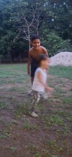 Family enjoys evening playtime in Venezuelan yard