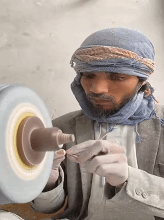 Traditional stone craftsmen work grinding wheels in Kandahar workshops