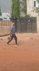 Man walks dirt road in casual clothing
