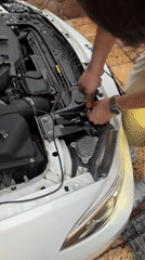 Evening car maintenance work documented in Arica, Chile