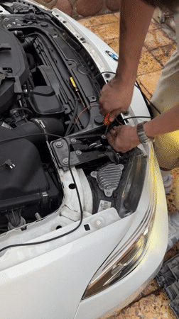 Evening car maintenance work documented in Arica, Chile