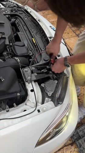 Evening car maintenance work documented in Arica, Chile