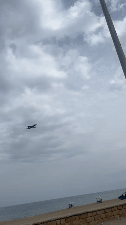 Ryanair aircraft departs over water near Martil, Morocco