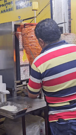 Late-night taco vendor prepares al pastor in Mexico