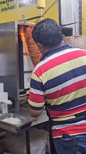 Late-night taco vendor prepares al pastor in Mexico