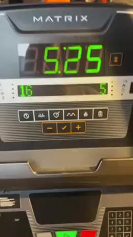 The video shows a close-up of the console of a Matrix treadmill in a gym. The digital display shows the time increasing from 8:28 to 8:30. The incline is set at 16 and the speed is set at 5. Other gym equipment and people walking around are visible in the blurry background.