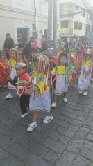 Traditional cultural parade with children dancers in Amaguaña Ecuador