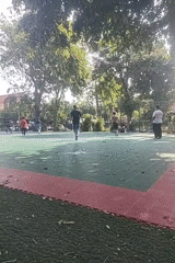 Pickup soccer game on a neighborhood turf court in Surabaya