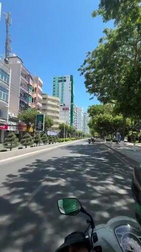 Motorcycle rider documents sunny morning journey through coastal Nha Trang