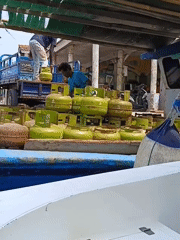 Boats, barges, and harbor work along the Jakarta coast