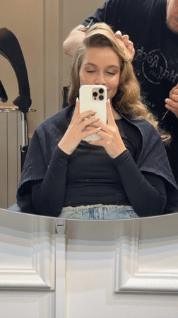 Woman styles hair at Belgrade salon, documents process