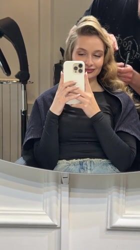 Woman styles hair at Belgrade salon, documents process