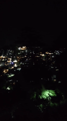 Nighttime settlement lights captured in mountainous terrain