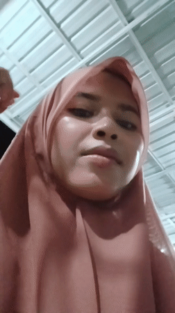 Woman in pink hijab documented in Lhokseumawe, Indonesia