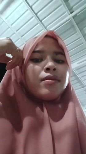 Woman in pink hijab documented in Lhokseumawe, Indonesia
