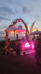 Evening oceanside party with DJ, pool gathering in Kediri