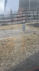 Hailstorm blankets Aldermaston landscape near metallic building