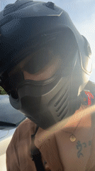 Person in black JPX motorcycle helmet captured on video