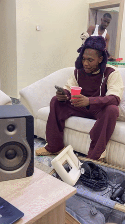 Casual indoor gathering documented in Gwarinpa residential space