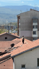 Two men film rooftop selfies in sunny Plovdiv