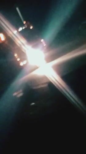 Night traffic and neon lights across Bukuru, Nigeria