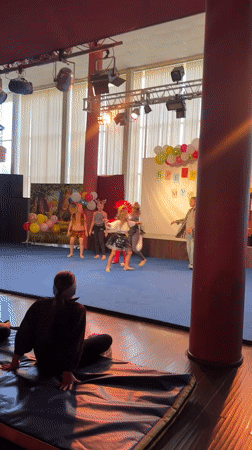 Kids' costume performance on a decorated stage in Veliky Novgorod