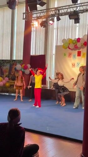 Kids' costume performance on a decorated stage in Veliky Novgorod