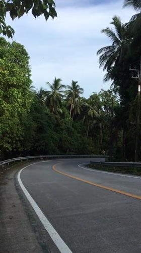 Curved road with guardrails documented in rural Thailand