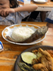 Indonesian family shares evening meal at outdoor restaurant