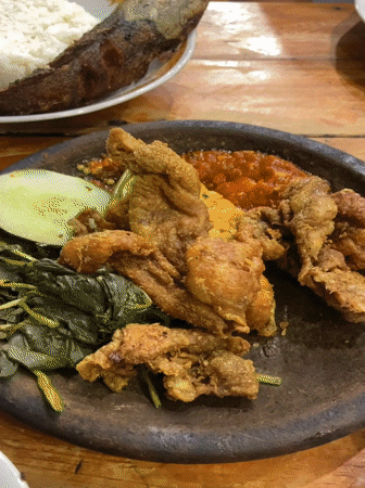 Indonesian family shares evening meal at outdoor restaurant