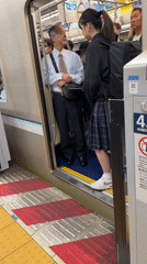 Evening train passengers board and disembark at station platform