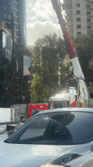 Early morning construction crane lifts glass at Tel-Aviv building site