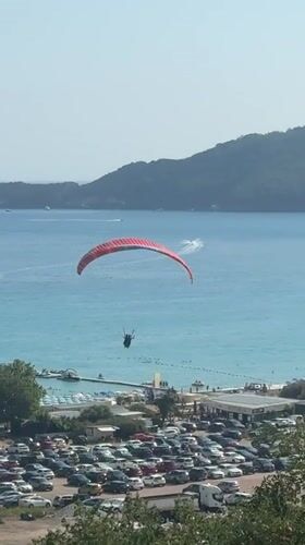 Paragliders over Boreti's coastline on a sunny afternoon