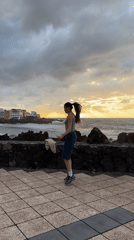Woman jump ropes on seaside walkway during sunset in Puerto de la Cruz