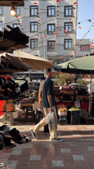 Sidewalk shoe stall on a busy Tehran street