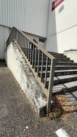 A person is shown on a scooter in a variety of locations. The video begins with the person on a scooter at the top of a set of outdoor stairs, they then proceed down the stairs on the scooter. The video then transitions to the person on the scooter in a parking lot. The person is on the scooter in a parking lot with cars and a building in the background. The video ends with the person on the scooter in the parking lot.