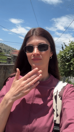 Woman films herself while walking in sunny Podgorica