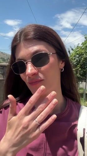 Woman films herself while walking in sunny Podgorica